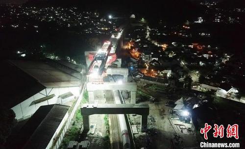 中国侨网22日凌晨,印尼雅万高铁全线唯一一处上跨印尼既有铁路箱梁完成架设。 王增堃 摄