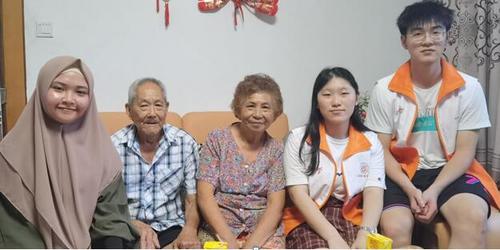 中国侨网归侨老人江玉美与志愿者合影。 (张笑嫣 摄)